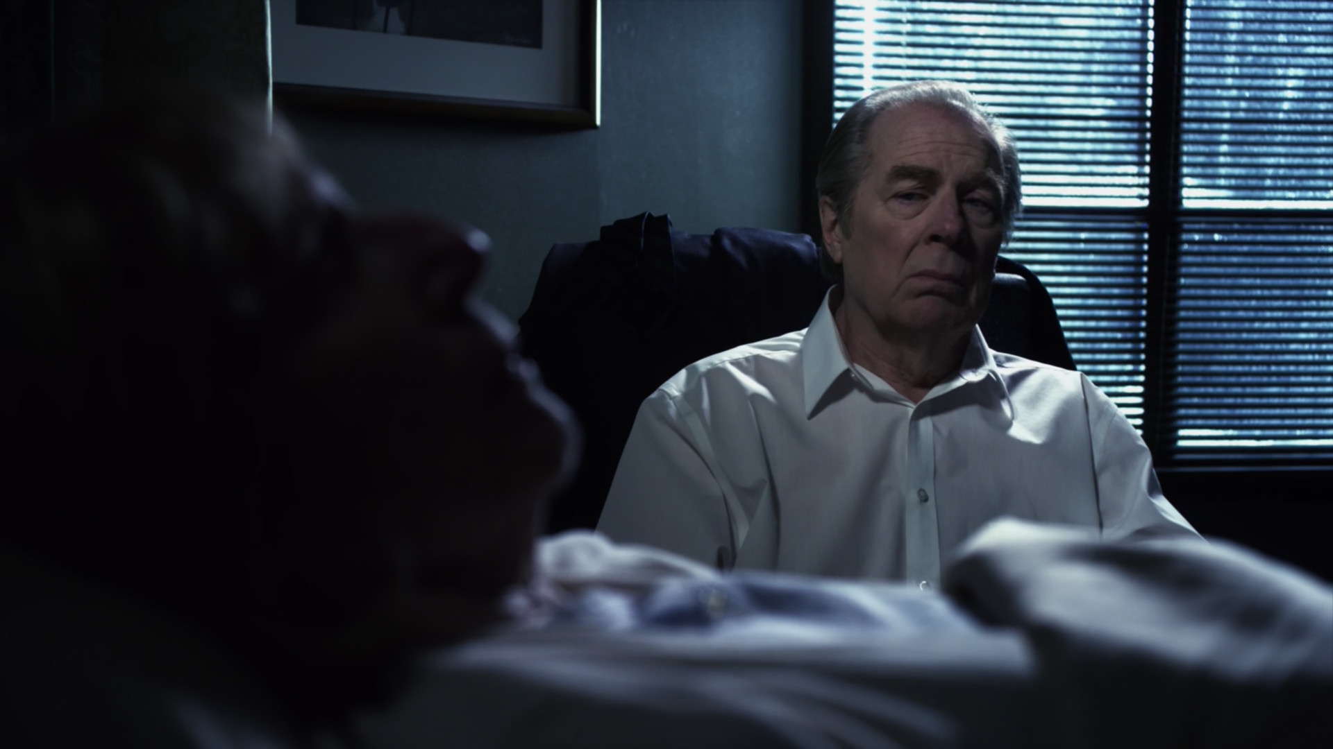 Chuck sits beside his mother as she dies