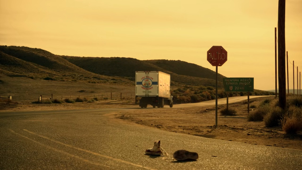 A Los Pollos Hermanos truck drives off in front of a pair of sneakers