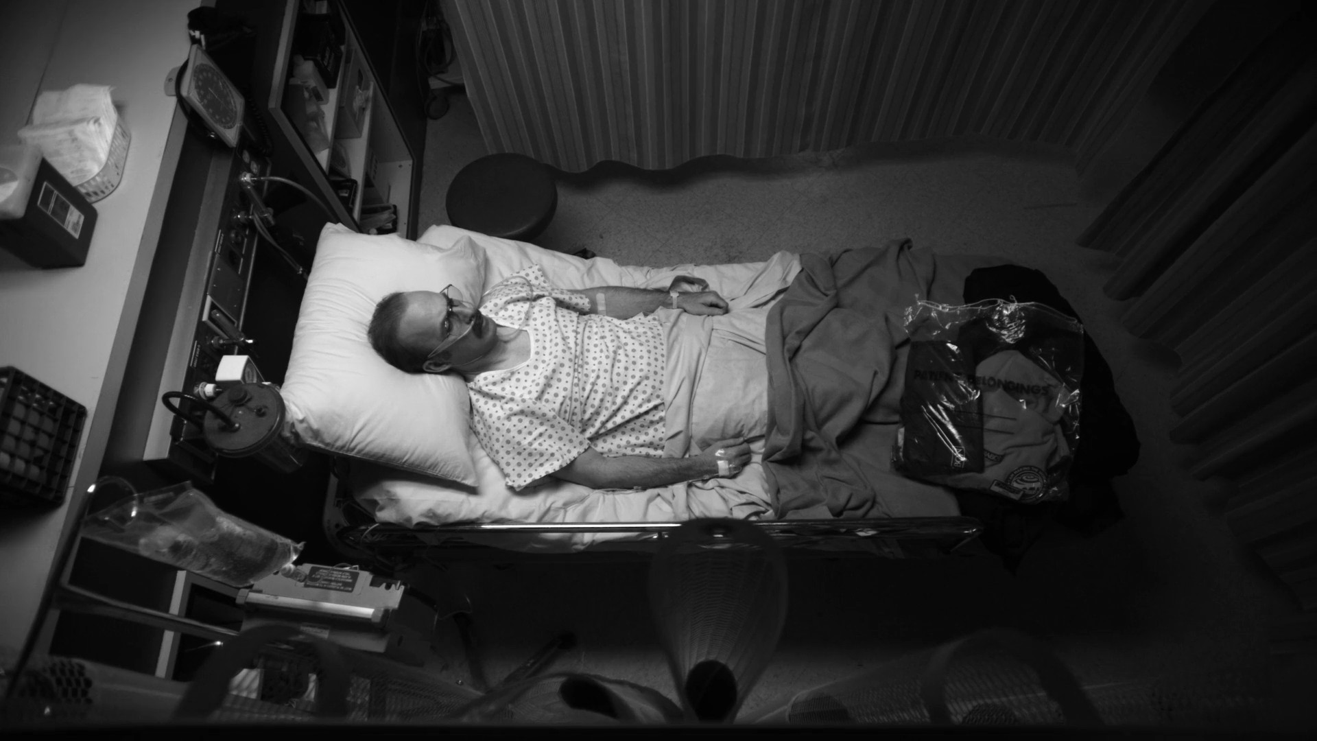 Saul lies in a hospital bed