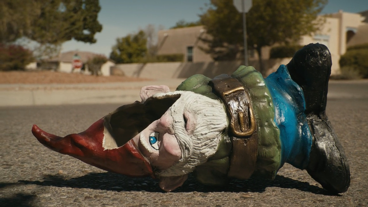 A garden gnome is left in the middle of the street
