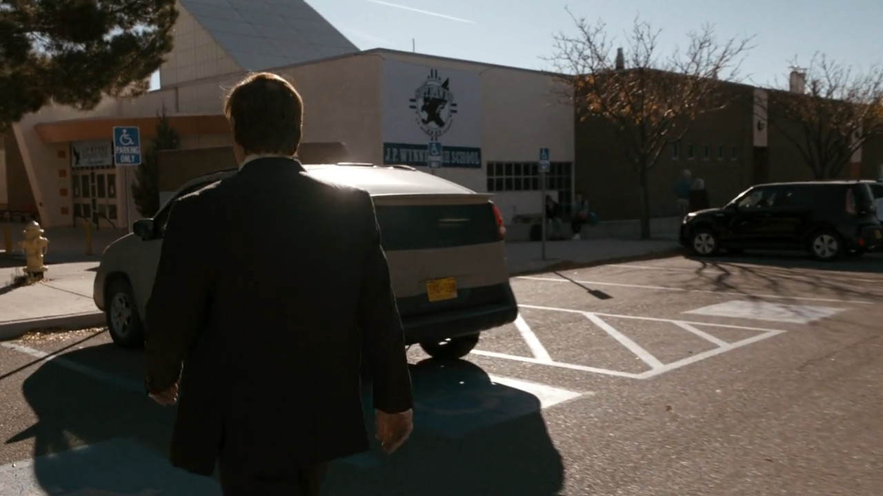 Saul walks up to the door of Walter White's school