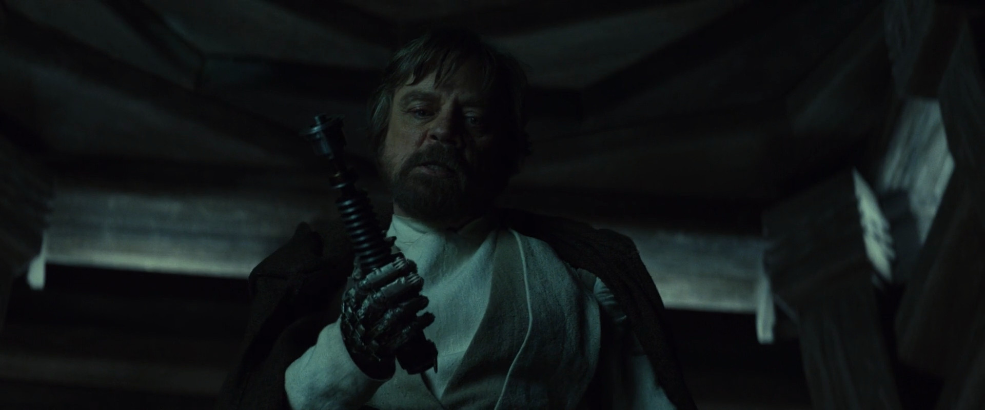 Luke Skywalker readying his lightsaber to attack Kylo Ren